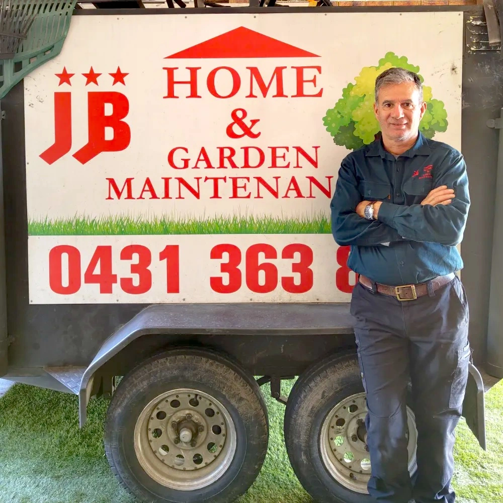 Antonio standing proudly in front of his work truck showcasing His branding.